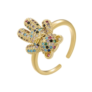 Macro detail of golden bear ring featuring vibrant multi-colored gemstone settings