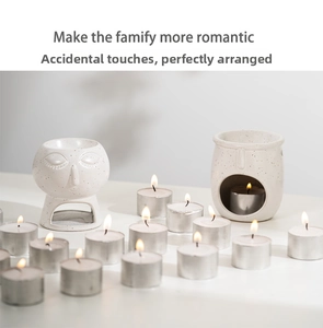 Close-up of abstract ceramic essential oil burner and tea light candles in home spa setting