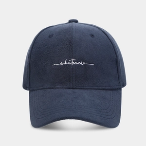 Dark blue suede baseball cap with white whatever embroidery in a classic six-panel design