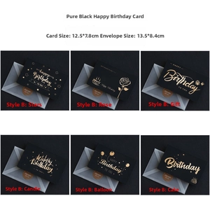 Detail view of black birthday cards with gold foil patterns and matching envelopes