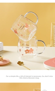 Detail of cherry blossom glass cup with crown lid and golden flower spoon in pink tones