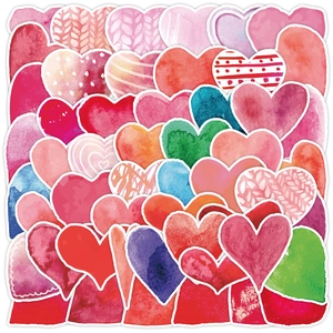 Detailed macro shot of vibrant watercolor heart stickers with artistic hand-drawn patterns