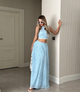 Détail du haut sans manches bleu clair avec broderie ajourée et jupe longue assortie pour femme
