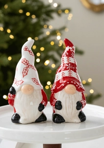 Close-up of ceramic Christmas gnomes with white beard and festive holly patterns