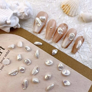 Baroque pearl nail art charms on nude gradient nails with elegant shell decoration