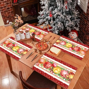 Christmas table runner and placemats set with festive red berries and gold ornaments