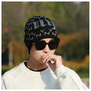 Close-up of winter beanie with thick jacquard knit and gray NY pattern embroidery