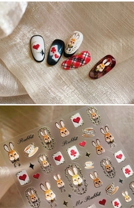 Detail of vintage palace style nail stickers with rabbit and poker card patterns