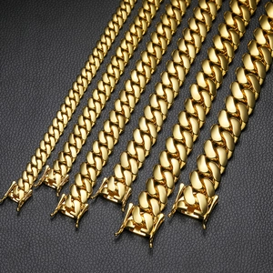 Comparison of golden Cuban link chains in various widths on a black textured background