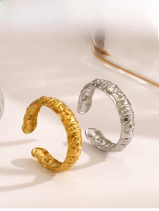 Detail of adjustable gold and silver rings with embossed vintage floral patterns