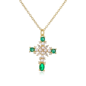 Detail of cross pendant with green gemstone, pearls and crystals on gold necklace chain