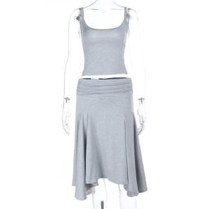 Detail of grey knitted fabric texture on the crop top and ruffled asymmetric skirt set