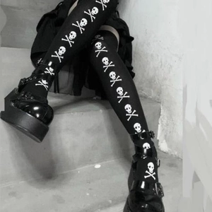 Gothic over-knee skull print stockings paired with black platform Mary Jane shoes