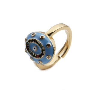 Macro detail of gold devil eye ring featuring blue enamel and colorful rhinestones