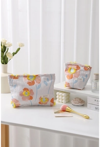 Detailed view of gray floral makeup bags with sunflower embroidery and H&R brand tag
