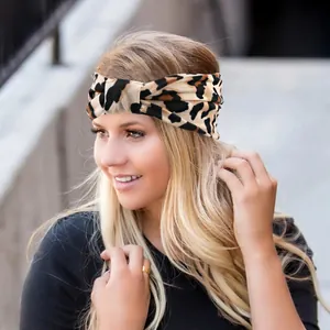 Outdoor model wearing a leopard print wide twisted headband with elastic fabric