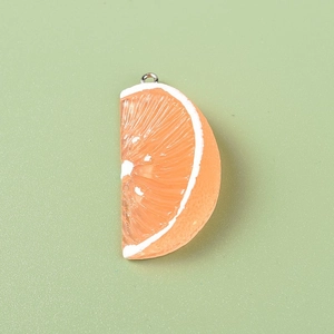 Macro detail of resin orange slice pendant with realistic texture and metal ring