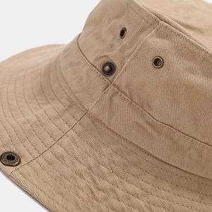 Close-up of khaki cotton sun hat with reinforced stitching, metal eyelets, and side snap