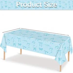 Detail view of light blue disposable tablecloth with navy bows measuring 108x54 inches
