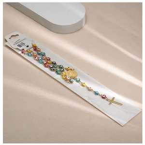 Detailed macro view of colorful evil eye beads with a golden cross on stainless steel necklace