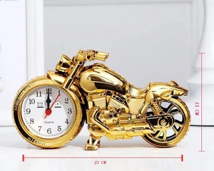 Detail of creative golden motorcycle alarm clock showing quartz dial and 23cm length size