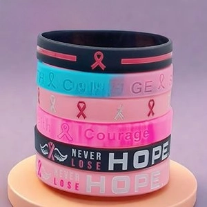 Close-up of silicone wristbands with Courage and Never Lose Hope motivational text