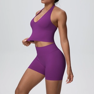 Macro detail of purple seamless ribbed fabric on yoga halter top and high waist shorts