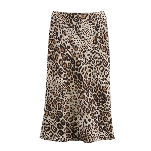 Macro shot of satin leopard print fabric texture and smooth hem of the midi skirt
