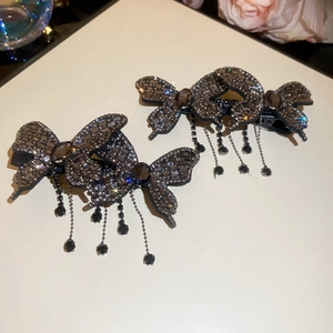 Detailed macro view of the butterfly hair clip with sparkling rhinestones and beaded tassels