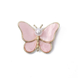 Elegant golden butterfly brooch with pink shell wings and a central white pearl inlay