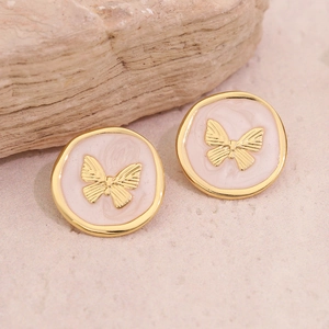 Boucles d'oreilles papillon vintage français en or et rose sur fond de pierre naturelle