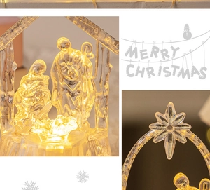 Close-up of transparent acrylic LED Nativity scene with warm yellow lighting and star detail