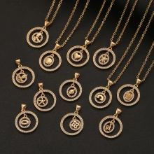 Detailed display of assorted gold zircon lightning and cross pendants on black background