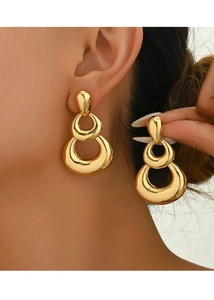 Detail of gold triple-hoop drop earrings showing polished oval links on a model