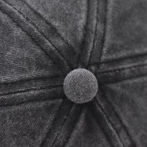 Close-up of the washed cotton baseball cap crown with stitched button and seam details