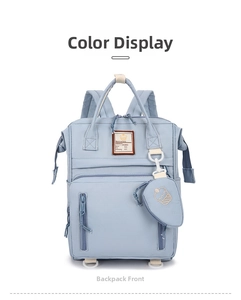 Close-up of light blue multifunctional backpack with embroidered cake pouch and front label