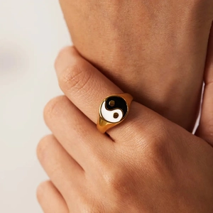 Professional lifestyle photo of a gold-plated stainless steel Yin Yang signet ring for men