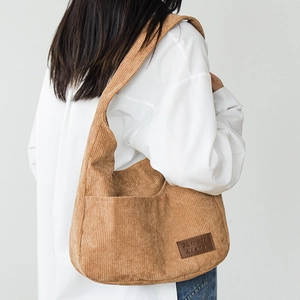 Chic corduroy tote bag in khaki, shown as a stylish shoulder bag on a model back view