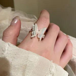 Detail of elegant butterfly zircon ring featuring soft pearlescent wings and silver band