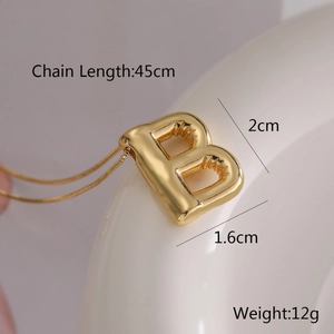 Detail view of gold balloon letter B pendant necklace with specific size dimensions