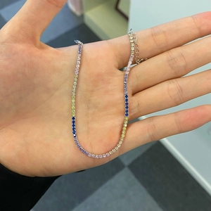 Close-up of sparkling colorful tennis necklace with silver adjustable extender chain