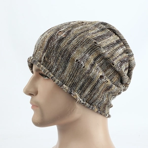 Detailed close-up of distressed knit beanie featuring mixed multicolor yarn and ripped texture