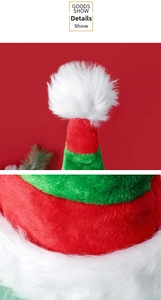 Close-up of thick plush fabric texture and white pompom on the red and green elf hat