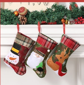 Detailed close-up of three knitted Christmas stockings with Santa, snowman and reindeer