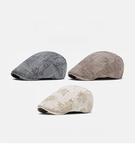 Detailed close-up of plaid and maple leaf patterns on British style flat caps