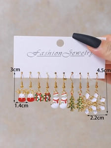 Close-up of five pairs of Christmas earrings on a display card with detailed measurements