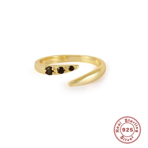 Detail of S925 sterling silver gold ring with three graduated black round zircons