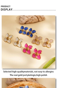 Detail of colorful enamel flower earrings with gold-plated PVD finish and polished texture