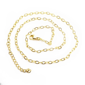 Detailed close-up of golden ball chain necklace with lobster clasp and extension