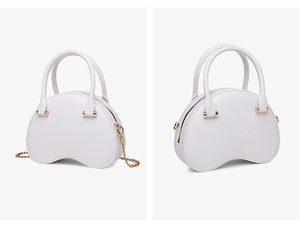 Detail view of white shell-shaped PVC jelly bag with gold chain strap and metal hardware